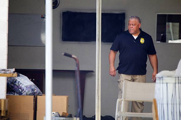An investigator is shown during a Homeland Security raid at a warehouse space behind the Power Exchange sex club on Highland Drive Wednesday, July 17, 2013.
