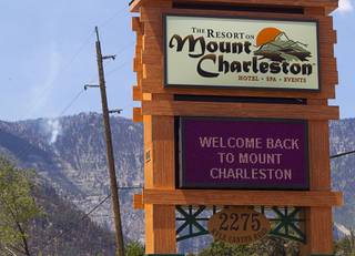 A Resort at Mount Charleston sign board sends a welcome to visitors Thursday, July 18, 2013. The mountain is expected to reopen to the public on Friday.