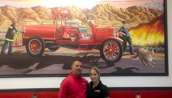 Kris and Kelley Fleck owners of hte Firehouse Subs on 7865 W. Sahara Ave pose in their restaurant's lobby.