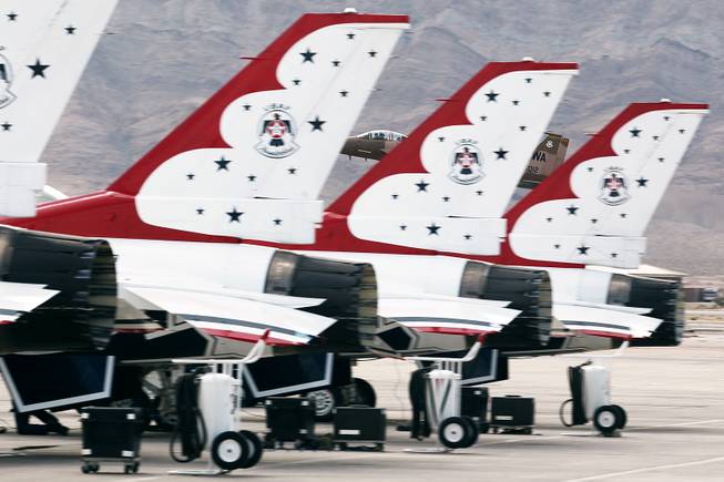 An F-15 attached to the 57th Wing based at Nellis Air Force Base is seen behind the tails of the Thunderbirds F-16's Tuesday, July 22, 2013.