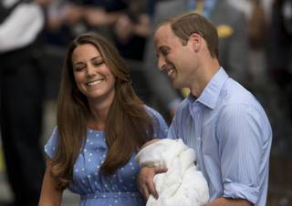 Britain's Prince William and Kate, Duchess of Cambridge react as they talk to the media whilst holding the Prince of Cambridge, Tuesday July 23, 2013, after posing for photographers outside St. Mary's Hospital exclusive Lindo Wing in London where the Duchess gave birth on Monday July 22. 