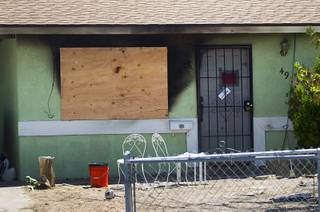 A home in Henderson is shown after a deadly fire Wednesday, July 24, 2013. Two people died in the fire, Henderson Fire officials said.