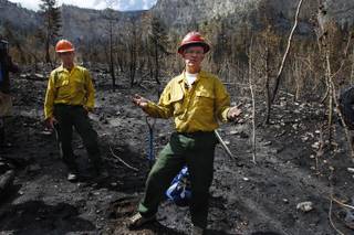 Hydrologist Brian Anderson and soil scientist Brad Rust, both from the U.S. Forest Service, speak to members of the media in a burned area near Cathedral Rock Wednesday, July 24, 2013 as a result of the recent fire on Mount Charleston.