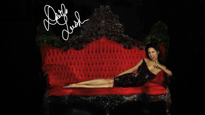 Although completely nude, burlesque performer Darla Lush appears to be clothed using projection mapping technology at the El Cortez on Tuesday, July 23, 2013.  She plans to incorporate the technology into her striptease act. The couch she is sitting on is also projection mapped -- in real life it looks nothing like the one in this picture.