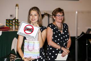 Intern Pastor Kaitlyn Ferguson, left, with the Rev. Marta Poling-Goldenne, co-pastor of New Song Church in Henderson, shows a gift she received at a farewell party at the church on Saturday, July 27, 2013. Ferguson will soon complete her one-year internship at the church. 