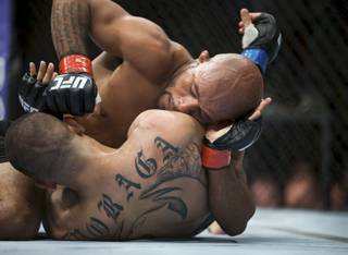 UFC flyweight champion Demetrious Johnson, top, fights John Moraga, bottom, during their bout in Seattle on Saturday, July 27, 2013. Johnson used an armbar on Moraga late in the fifth round and successfully defended his title. (AP Photo/The Seattle Times, Marcus Yam) SEATTLE OUT, USA TODAY OUT  MAGS OUT  NO SALES  TV OUT  MANDATORY CREDIT