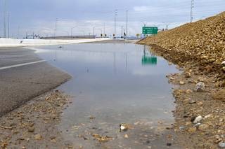 Storm runoff covers the roadway at the Flamingo Road exit on I-215 Sunday, July 28, 2013. The exit was temporarily closed until the water receded.