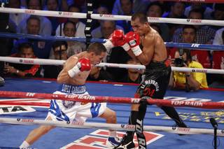 In this July 27, 2013, photo, Mexico's Juan Francisco Estrada, left, fights against Milan Melindo of the Philippines during their WBO/WBA Flyweight title match at the Cotai Arena in Venetian Macao in Macau. A Chinese fighters victory at a Macau showdown brings the worlds top casino market a step closer to challenging Las Vegas for dominance of another Sin City staple: big-time boxing matches. Macau, which long ago eclipsed Vegas as the world's top gambling city, is now looking to add to its allure by holding the kind of boxing bouts that Las Vegas is known for.