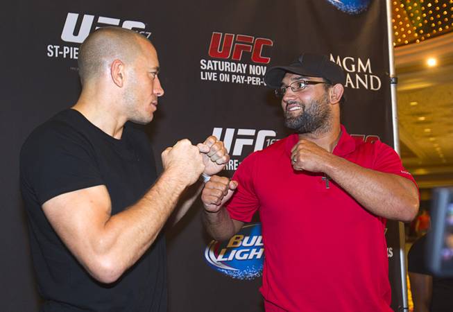 UFC welterweight champion Georges St. Pierre, left, of Canada and Johny Hendricks of Dallas, Texas pose during a UFC news conference in the lobby of the MGM Grand Monday, July 29, 2013. St. Pierre will defend his welterweight title against Hendricks during UFC 167 on Nov. 17 at the MGM Grand.