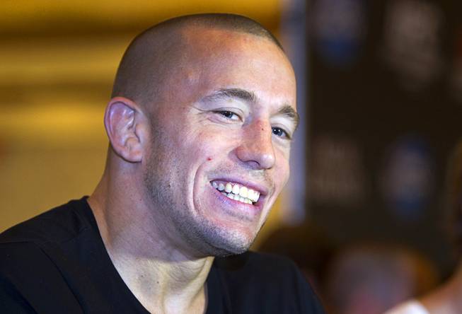UFC welterweight champion Georges St. Pierre of Canada smiles during a UFC news conference in the lobby of the MGM Grand Monday, July 29, 2013. St. Pierre will defend his welterweight title against Johny Hendricks of Dallas, Texas during UFC 167 on Nov. 17 at the MGM Grand.