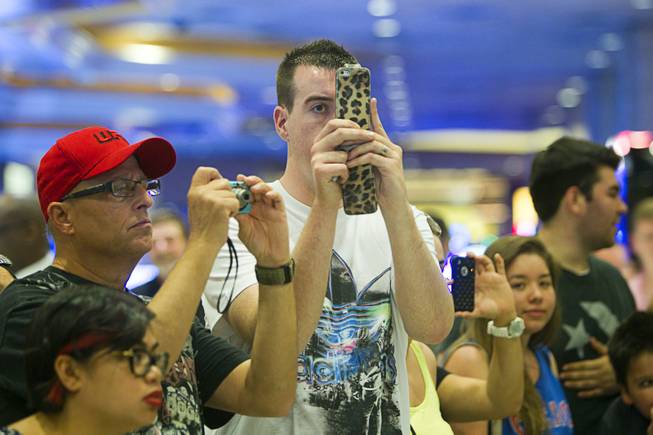 UFC fans take photos of UFC welterweight champion Georges St. Pierre of Canada and Johny Hendricks of Dallas, Texas during a UFC news conference in the lobby of the MGM Grand Monday, July 29, 2013. St. Pierre will defend his welterweight title against Hendricks during UFC 167 on Nov. 17 at the MGM Grand.