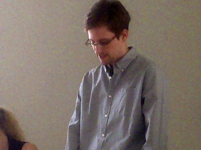 In this handout file photo taken on Friday, July 12, 2013, and made available by Human Rights Watch shows NSA leaker Edward Snowden during his meeting with Russian activists and officials at Sheremetyevo airport, Moscow, Russia . 