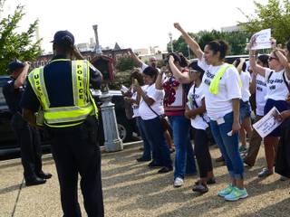 Pro-immigration demonstrators stand outside of the Longworth House Office Building in Washington, D.C., chanting slogans and cheering on their fellow protesters being carted off after arrests, not shown, Thursday, July 31, 2013.