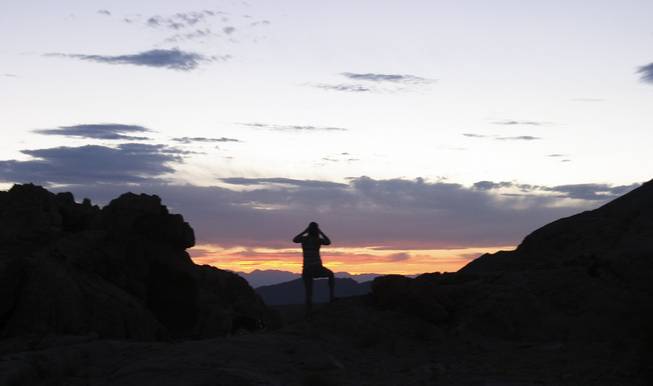 Chiara Velotta photographs the disappearing sun at Gold Butte, Aug. 3, 2013.