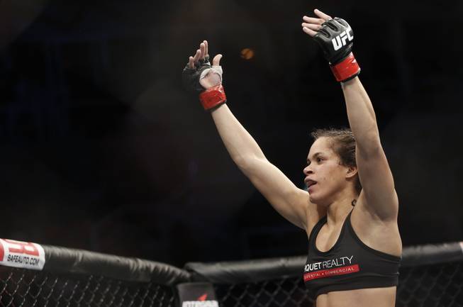 Amanda Nunes, from Brazil, celebrates after defeating Sheila Gaff, from Germany, during their UFC 163 mixed martial arts Women's Bantamweight bout in Rio de Janeiro, Brazil, Saturday, Aug. 3, 2013. 