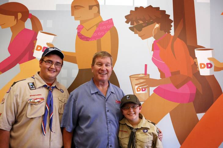 Charlie Mootz, center, with Donald Swanson, 17, and his brother James Swanson, 11, inside the Dunkin' Donuts franchise that he owns in Henderson on Tuesday, Aug. 6, 2013.