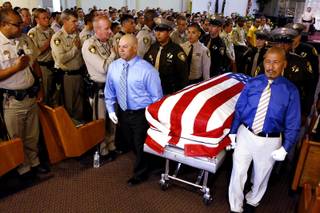 Ernesto Velasquez, left, father of Angel Velasquez, and Ricky Medrano, the stepdad of Angel Velasquez, carry the casket out after the service for Angel Velasquez at Trinity Life Center in Las Vegas on Wednesday, August 7, 2013. The 19-year-old Metro Explorer was killed August 1 by a suspected impaired driver.