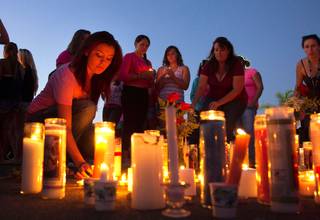 Athena Stewart lights a candle during a vigil for Hannah, 16, and Ethan, 8, Anderson Tuesday night, Aug. 6, 2013,  at El Capitan High School in Lakeside, Calif. The siblings have been missing since Sunday night and are believe to have been kidnapped by James Lee DiMaggio who is suspected of killing Christina Anderson, the children's mother.