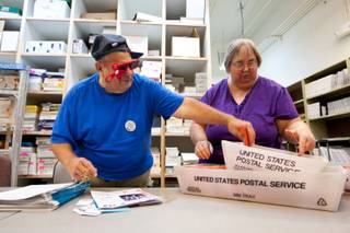Fred and Marion Rose, volunteers traveling from Galveston, Texas, work together organizing pamphlets to hand out at local community events at Nevada PEP Headquarters in Las Vegas Friday, August 9, 2013.