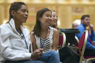 New teacher Jenny Nguyen, center, listens to Las Vegas Mayor Carolyn Goodman during a Clark County School District orientation session for new teachers at the Venetian Thursday, Aug. 15, 2013. Over 1,700 teachers took part in the orientation.