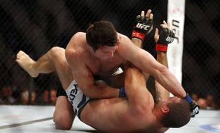 Chael Sonnen, top, lands a punch against Mauricio 'Shogun' Rua, of Brazil, during their UFC on Fox Sports 1 mixed martial arts light heavyweight bout in Boston, Saturday, Aug. 17,2013. Sonnen won via first-round tapout via guillotine choke. (AP Photo/Gregory Payan)