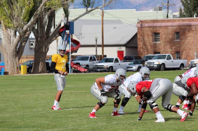 UNLV sophomore quarterback Nick Sherry calls out a play at the Rebels' scrimmage on Saturday, August 17, 2013, in Ely.