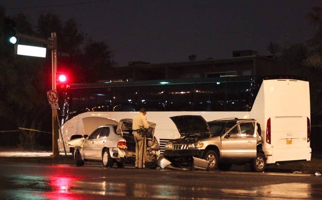 A five car accident, including a tour bus, is seen on Oneida Way and Desert Inn during a rainy evening, Sunday, Aug. 19, 2013.