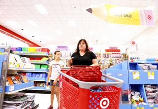 Dianne Lommason, center, seen with daughter Kristyn, left, 11, takes three of her daughters back-to-school shopping at Target in Las Vegas on Monday, Aug. 19, 2013.