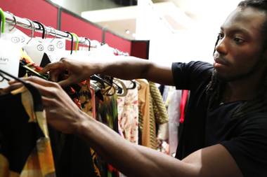 Urtreen White, 25, searches for the clothes he will model in a fashion show for Fashion Week Las Vegas at the Palms on Tuesday, August 20, 2013.