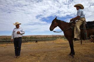 Rancher Cliven Bundy, left, and his son, Arden, stand on land the family has worked since the 1880s on August 20, 2013, in Bunkerville, Nevada. Bundy is battling the Bureau of Land Management over grazing rights. 