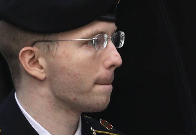 Army Pfc. Bradley Manning is escorted into a courthouse in Fort Meade, Md., Wednesday, Aug. 21, 2013, before a sentencing hearing in his court martial.
