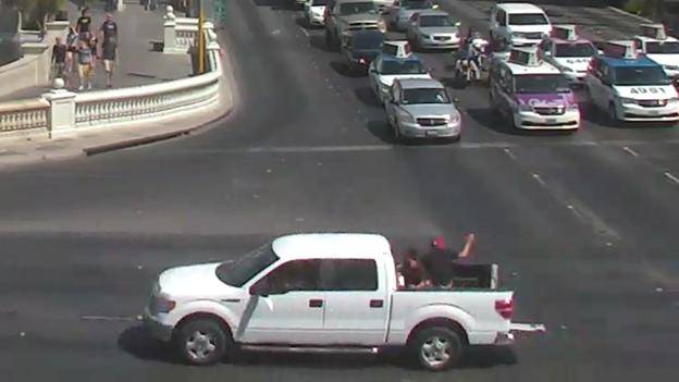 Jesus Magdaleno, an off-duty California Highway Patrol officer, and Felix Cruz are shown waving their arms in the back of a pickup that police say was stolen from the valet area of the Flamingo on Sunday, Aug. 18, 2013. The men suffered fatal injuries when the truck crashed into an SUV at Flamingo Road and Valley View Boulevard.