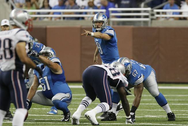 Detroit Lions quarterback Matthew Stafford signals at the line of scrimmage against the New England Patriots in the second quarter of an NFL preseason football game in Detroit, Thursday, Aug. 22, 2013. 