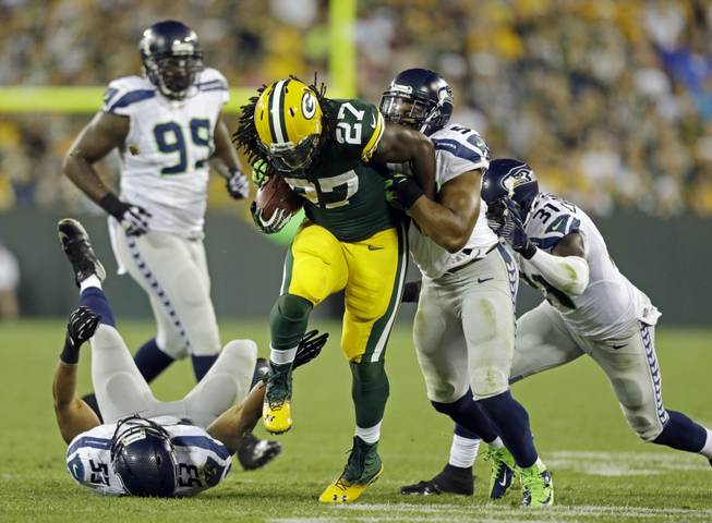Green Bay Packers' Eddie Lacy runs during the second half of an NFL preseason game against the Seattle Seahawks on Friday, Aug. 23, 2013, in Green Bay, Wis. 