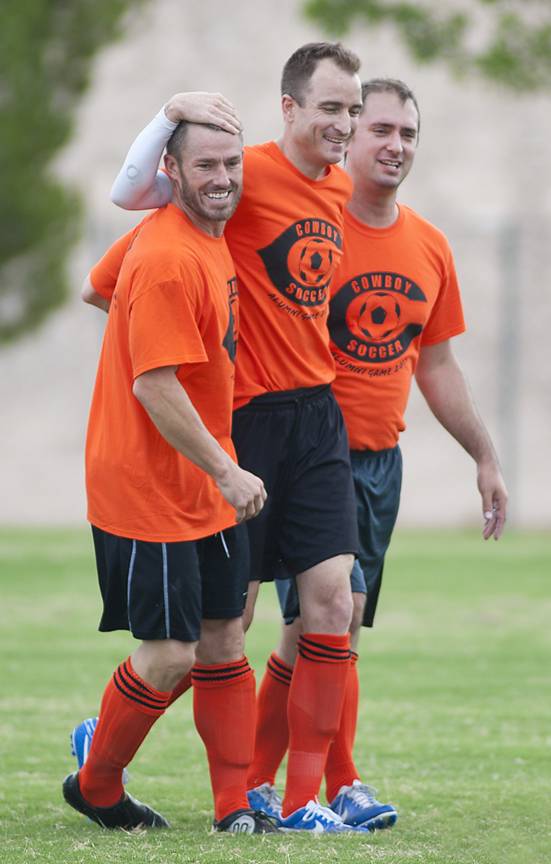 From left to right: Former Chaparral Cowboys soccer players Levi Parker, Danny Welsh and Billy Hayes get together to celebrate a Welsh goal scored against the current Cowboys roster at the school on Saturday.
