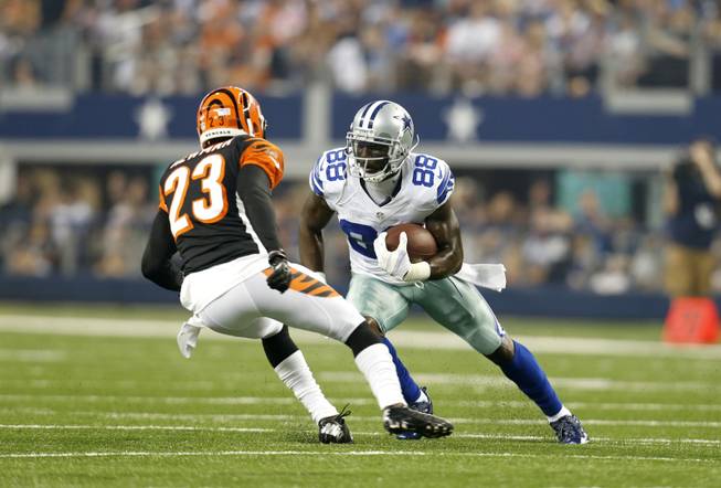 Dallas Cowboys wide receiver Dez Bryant (88) looks for running room against Cincinnati Bengals' Terence Newman (23) after a reception by Bryant during the first half of a preseason NFL football game, Saturday, Aug. 24, 2013, in Arlington, Texas. 