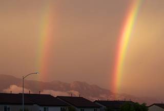 A double rainbow is shown above homes near El Capitan Way and Grand Teton Drive after a thunderstorm in the northwest part of the Valley Sunday, Aug. 25, 2013. 