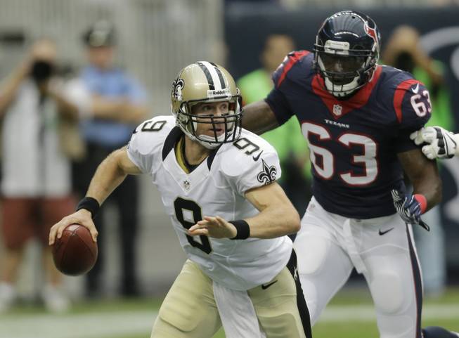 New Orleans Saints quarterback Drew Brees (9) throws a pass during the first half of a preseason NFL football game Sunday, Aug. 25, 2013, in Houston.