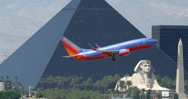 A Southwest Airlines flight approaches McCarran International Airport with the Luxor in the background.