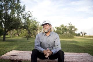 Paul Craig Cobb on a picnic table across from his house in Leith, N.D., Aug. 26, 2013. Cobb, a newcomer to Leith, which has a population of about 20 people, has been buying up property in an attempt to transform the town into a colony for white supremacists.