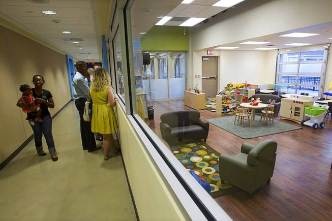 Guests look over classrooms after a grand opening ceremony for the 9th Bridge School in downtown Las Vegas Tuesday, Aug. 27, 2013. The private school/early childhood learning center, part of the Downtown Project, opened August 26 with infants through kindergarten students and will gradually add grades.