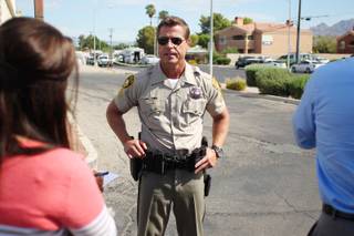 Metro Sgt. John Sheahan briefs members of the media about a hostage situation near Mountain Vista Street and Tropicana Avenue Tuesday, August 27, 2013. A woman is believed to be barricaded inside a home, possibly with two children and several weapons.