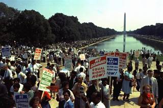 People carry civil rights signs as they gather in Washington, D.C. before Martin Luther King Jr.'s 