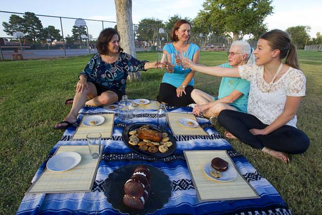 Supporters of raw milk toast with empty glasses during a "picnic" at Sunset Park Thursday, August 29, 2013. From left are: Patricia Aiken, Emily McFarling, Caroline Anaya, and Juliana Whitney. The Nevada legislature passed a bill that would have allowed raw milk produced in Nye County to be distributed statewide but Governor Brian Sandoval vetoed the bill. 