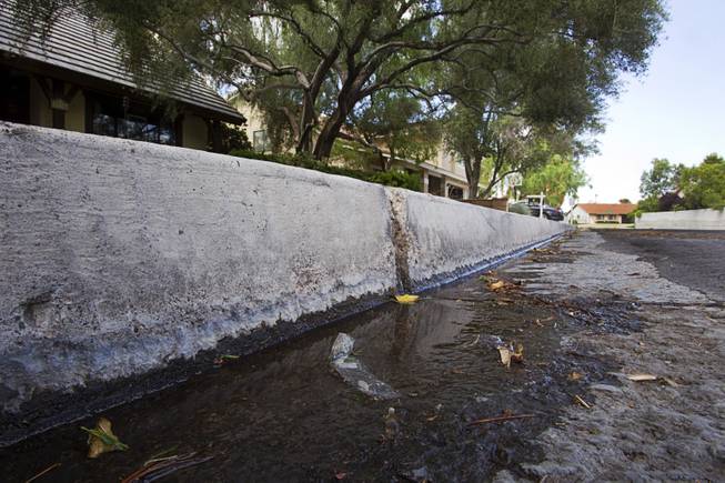 Water flows down the street from a home near Rancho Dr. and Oakey Blvd. Thursday, August 29, 2013. The lawn sprinklers were running at a prohibited time (between 11 a.m. and 7 p.m.) and overwatering so that water flowed into the gutter.