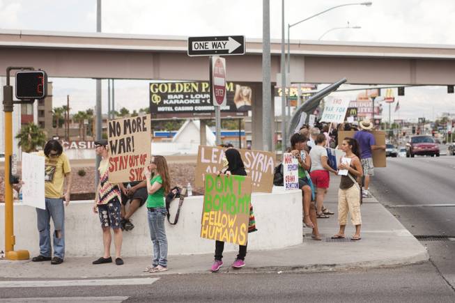 Protesters against U.S. intervention in Syria line the sidewalk on Tropicana and the I-15, Saturday, Aug. 31, 2013.