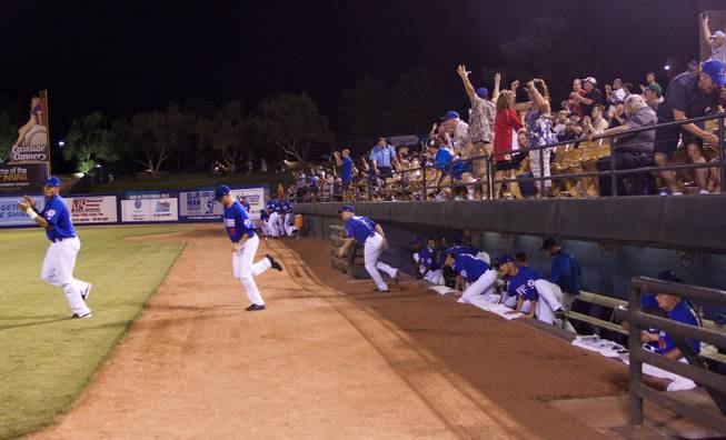 Fans cheer as the 51s players run out of the dugout after winning the Pacific Coast League Southern Division title beating Tuscan 8-6, Saturday, Aug. 31, 2013.