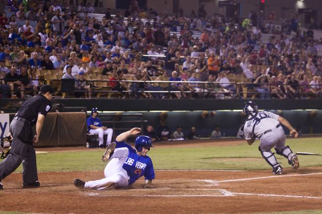 The Las Vegas 51s Eric Campbell slides into home  in the fifth inning during their game against Tucson, Saturday, Aug. 31, 2013. The 51s beat Tucson 8-6 to win the Pacific Coast League Southern Division title.