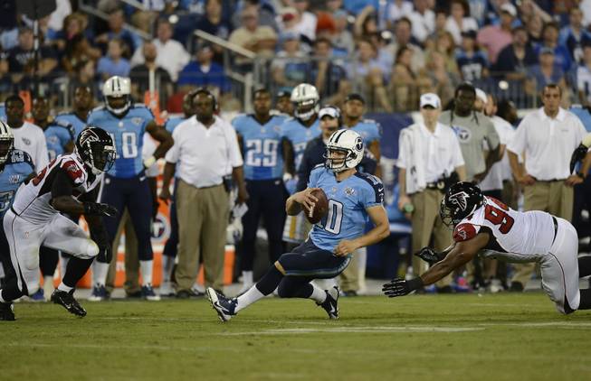 Tennessee Titans quarterback Jake Locker (10) falls to the turf after running against the Atlanta Falcons during the first half of an NFL preseason football game, Saturday, Aug. 24, 2013, in Nashville, Tenn. 