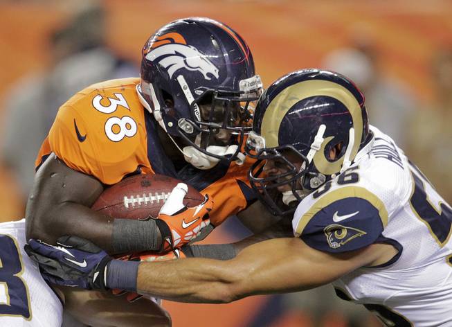 Denver Broncos running back Montee Ball (38) pushes through St. Louis Rams defensive back Robert Steeples (36) in the third quarter of a preseason NFL football game, Saturday, Aug. 24, 2013, in Denver.